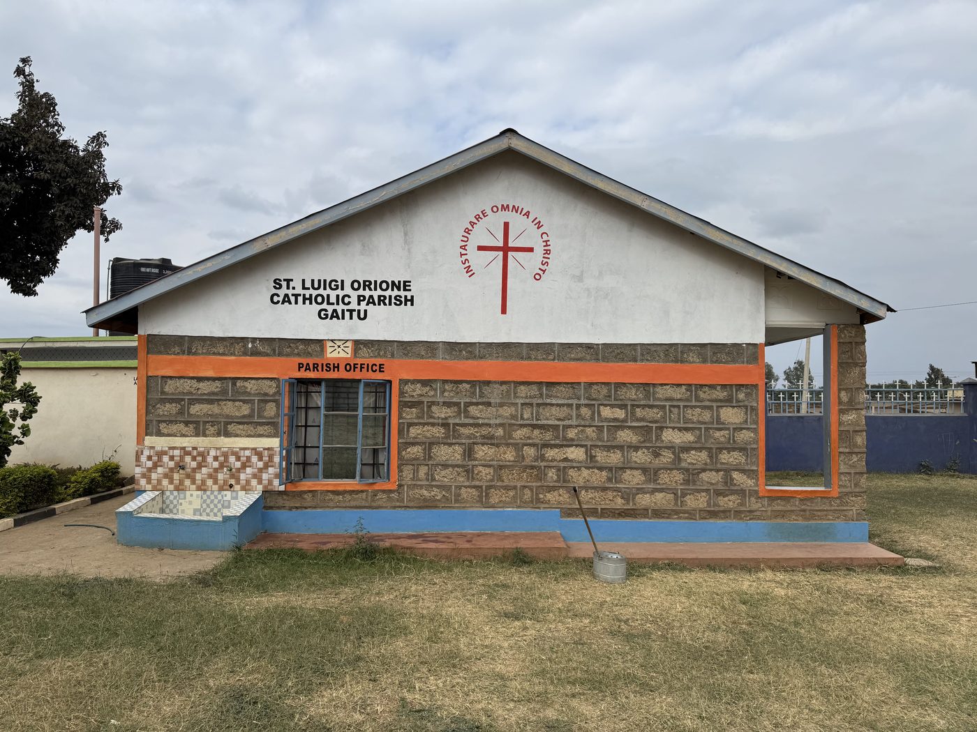 St. Luigi Orione Catholic Parish church, Gaitu — the stone facade with the parish sign
