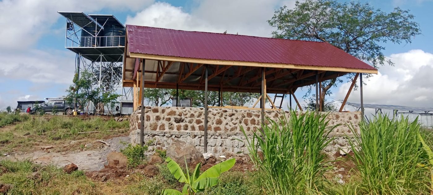 The stone base and timber roof of the first Isineti building