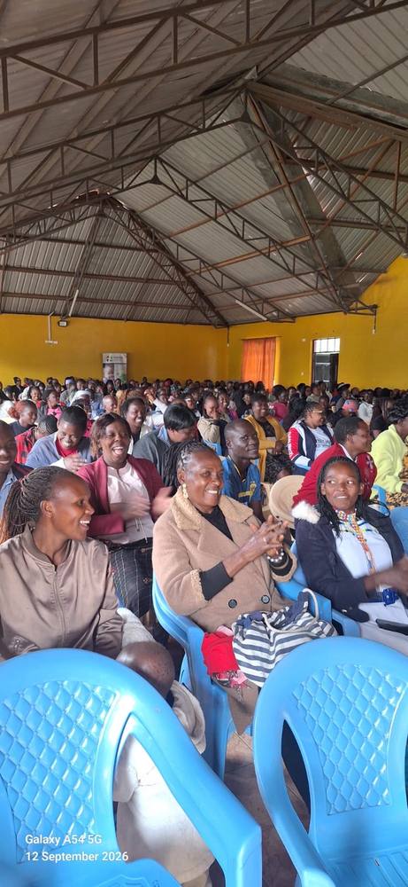 Parents and caregivers applaud during the graduation ceremony at Kandisi