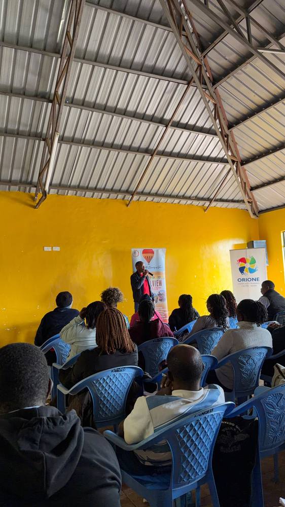 A speaker addresses participants at the Orione Community Training Centre