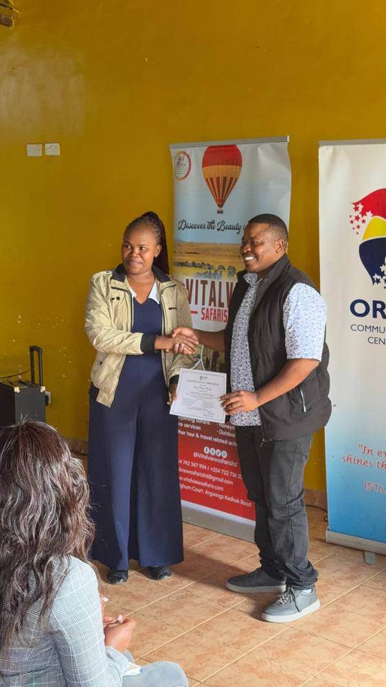 A graduate receives her certificate of completion
