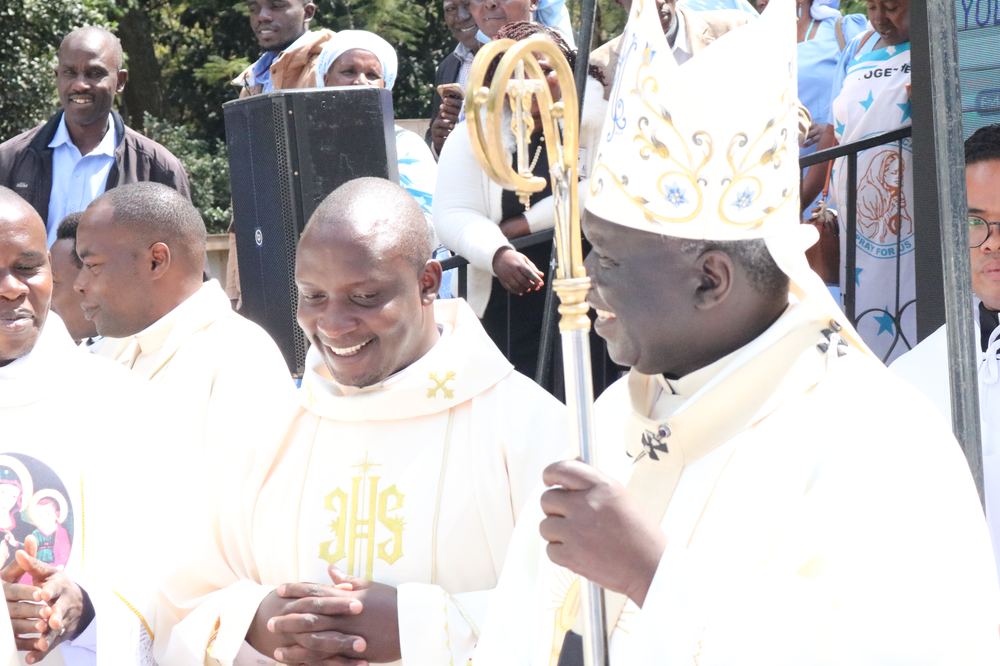 Deacon Justus Nyabuga Barongo walking in procession with the Archbishop