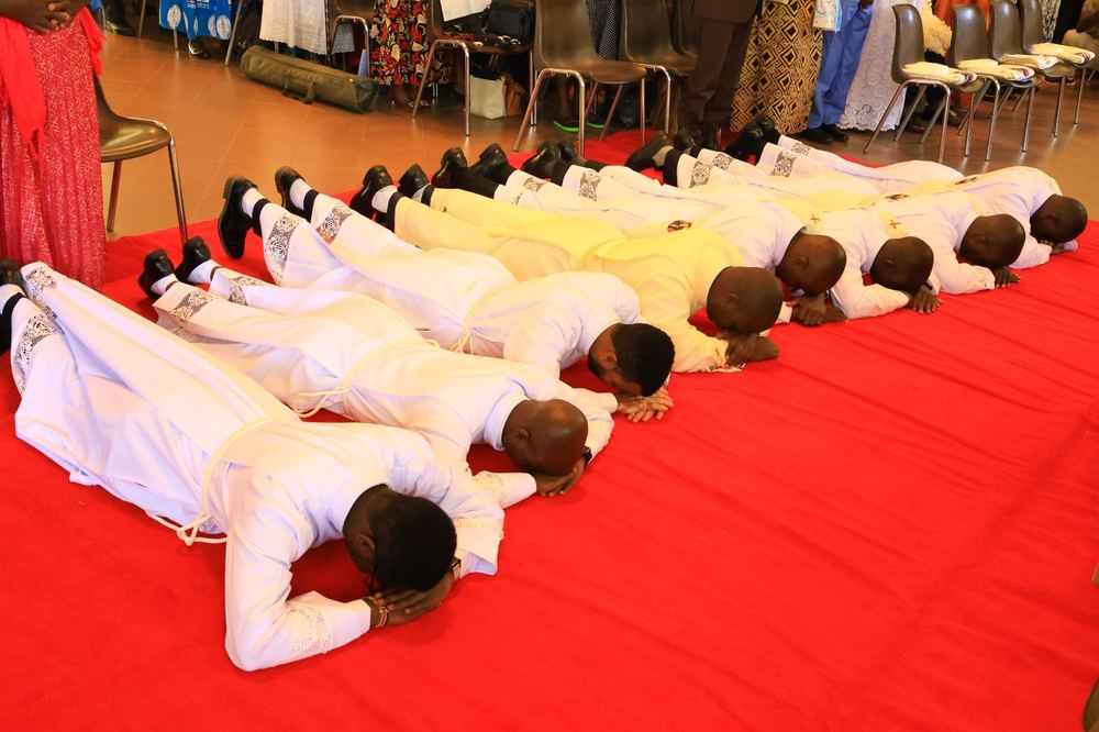 The newly ordained prostrate before the altar during the ordination rite