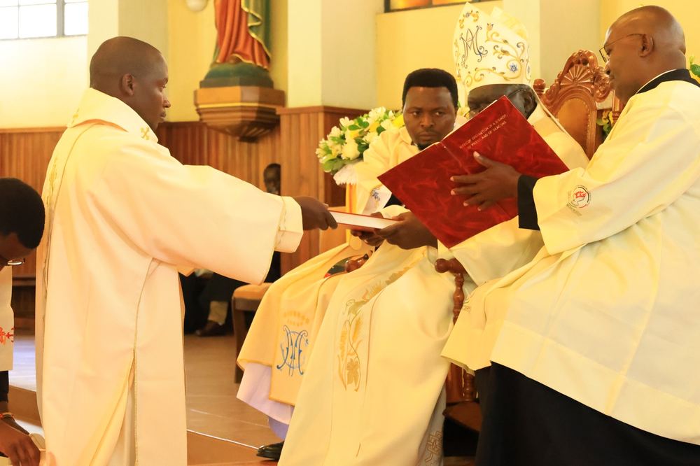 Archbishop Philip Anyolo receiving the rite of ordination