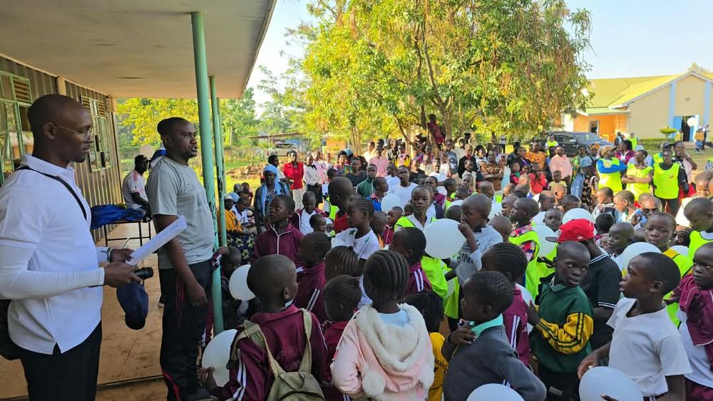 Learners lined up with white balloons ahead of the family walk