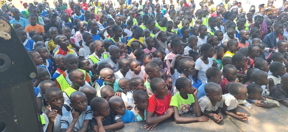 A large crowd of learners watching the launch ceremony